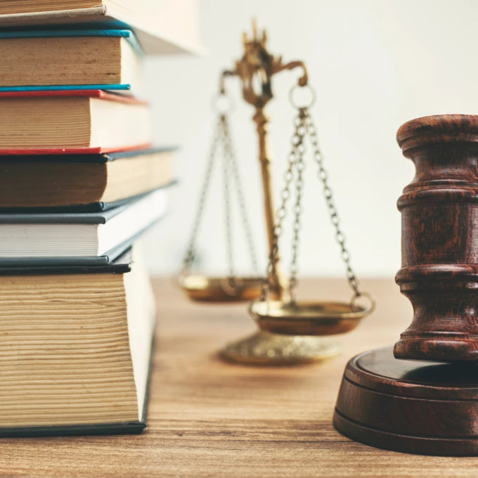 group s law books on lawyer desk at law firm